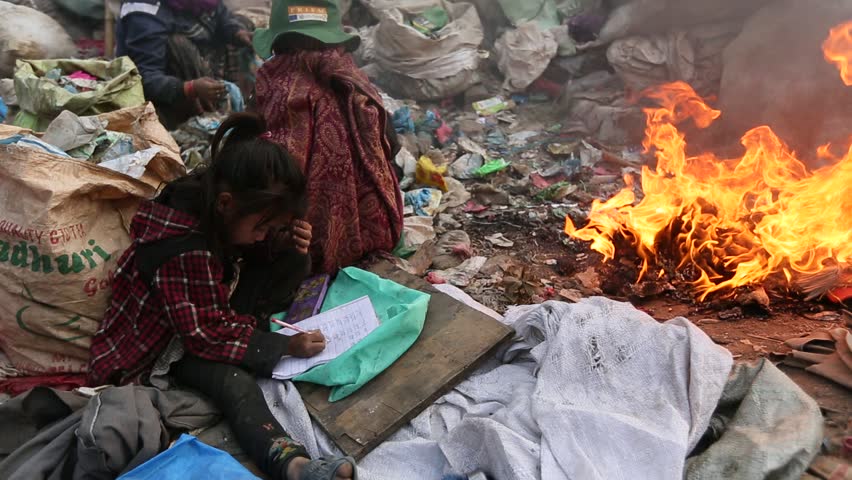 KATHMANDU, NEPAL - DEC 19: Unknown poor children makes the lessons on the dump,
