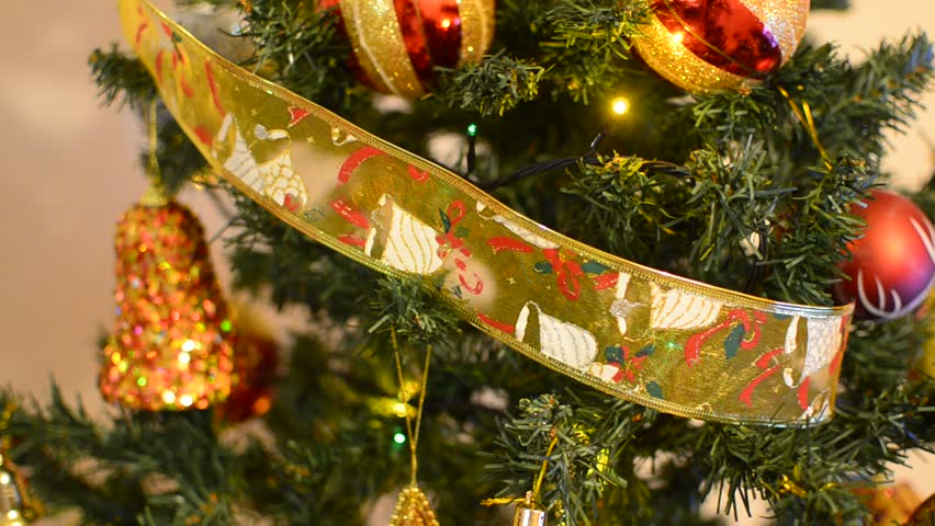 Putting decortion on Christmas tree, closeup