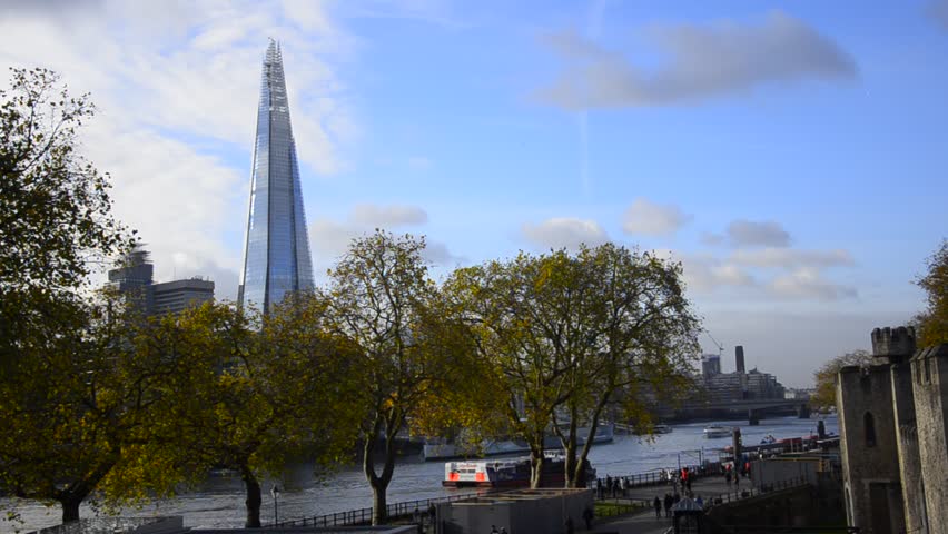 London dayscape of The Shard and boats passing thames river