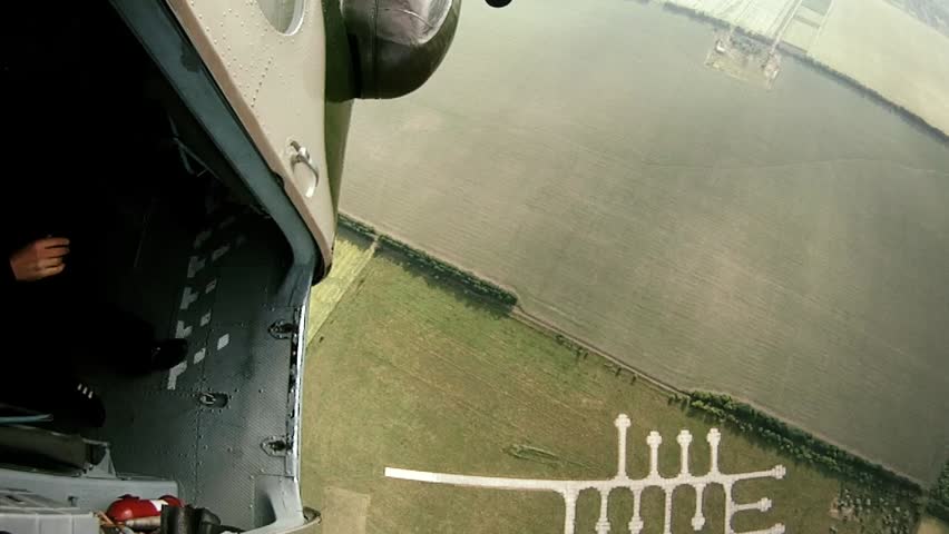 Team of parachutists jumping out of helicopter