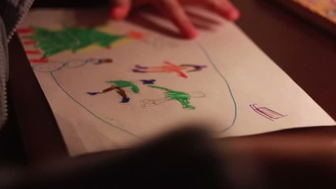 Boy draws a picture by candlelight. Turn off the electricity, global cataclysm

