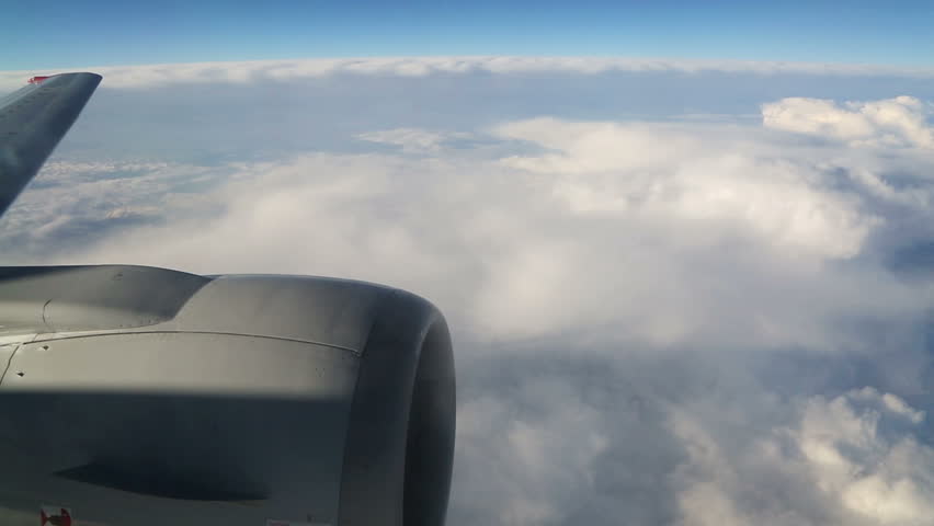 view from airplane on clouds wing and engine