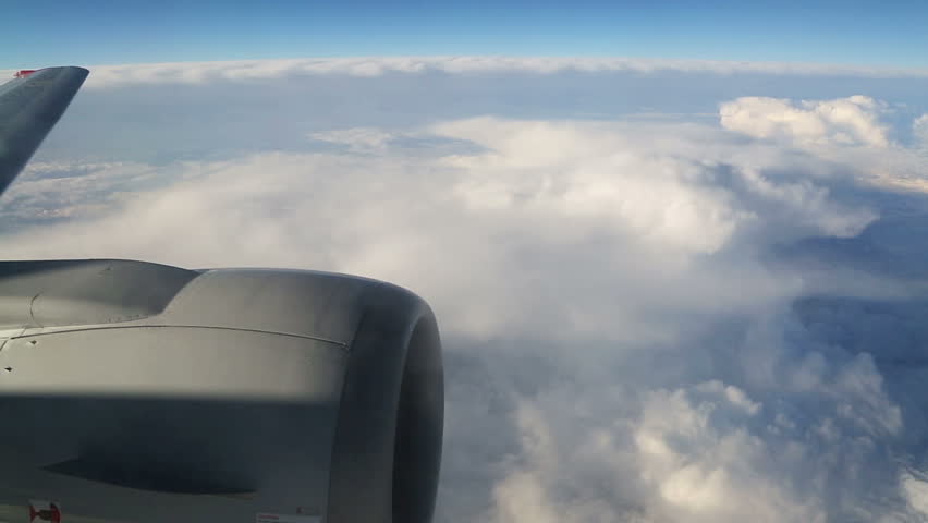 view from airplane on clouds wing and engine