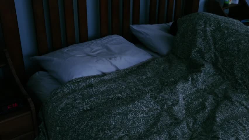 A man wakes up in bed without his wife beside him