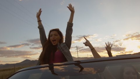 Teen Stands, Raises Her Arms & Yells In A Convertible To Celebrate w/Friends 
