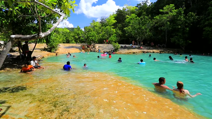 KRABI - CIRCA DECEMBER: Tourists bath in the emerald pool in the tropical forest