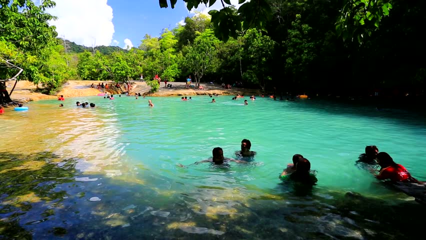 KRABI - CIRCA DECEMBER: Tourists bath in the emerald pool in the tropical forest