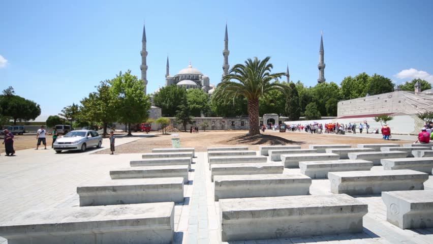 People walk near beautiful Sultanahmet Mosque (Blue Mosque) near Hagia Sophia in Istanbul, Turkey