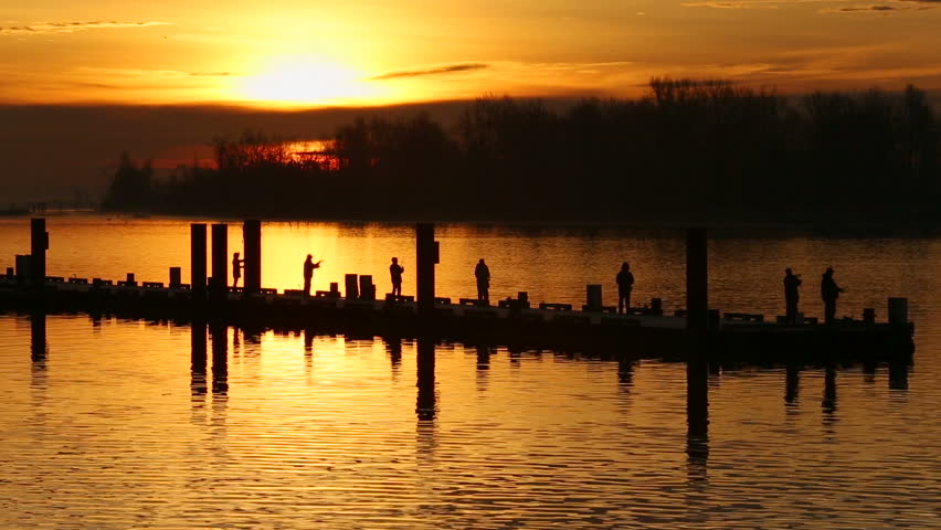 Steveston Harbor Sunrise Sport Fishermen. Fishermen line up on the floating dock in Steveston trying their luck at sunrise. Richmond, British Columbia, Canada.
