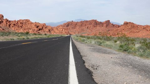 Man hitch hiking on desert highway