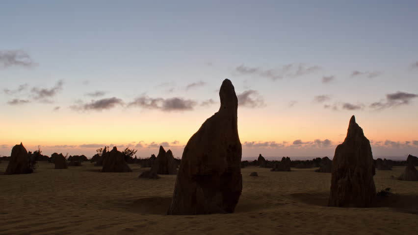 Time lapse of a silhouette of the pinnacles at sunset, with storm clouds brewing