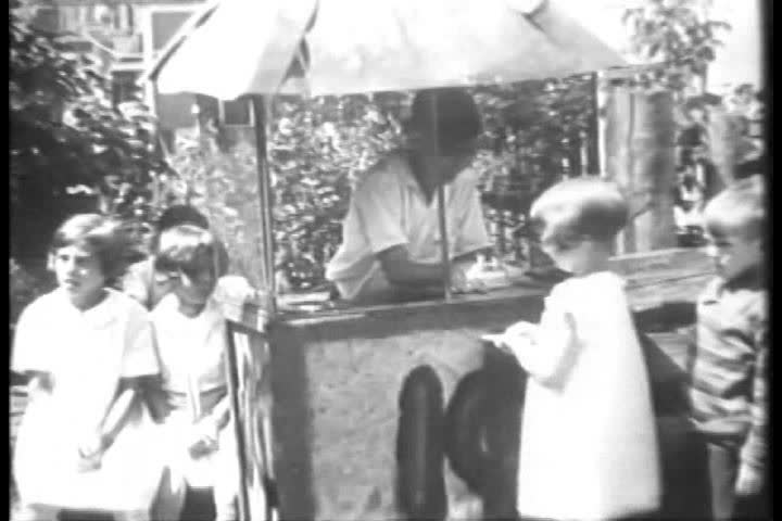 Kids enjoy a homemade amusement park in 1930.