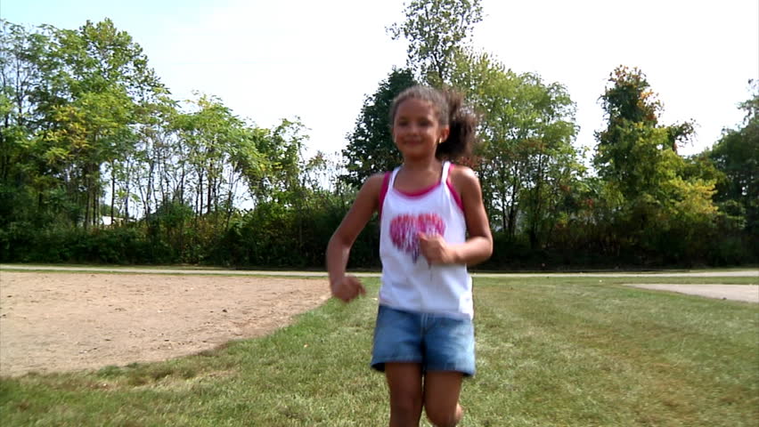 A young girl runs towards the camera.  Shot at 60fps.