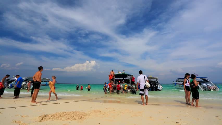 BAMBOO ISLAND, THAILAND - CIRCA DECEMBER: tourists disembark from speedboat, on