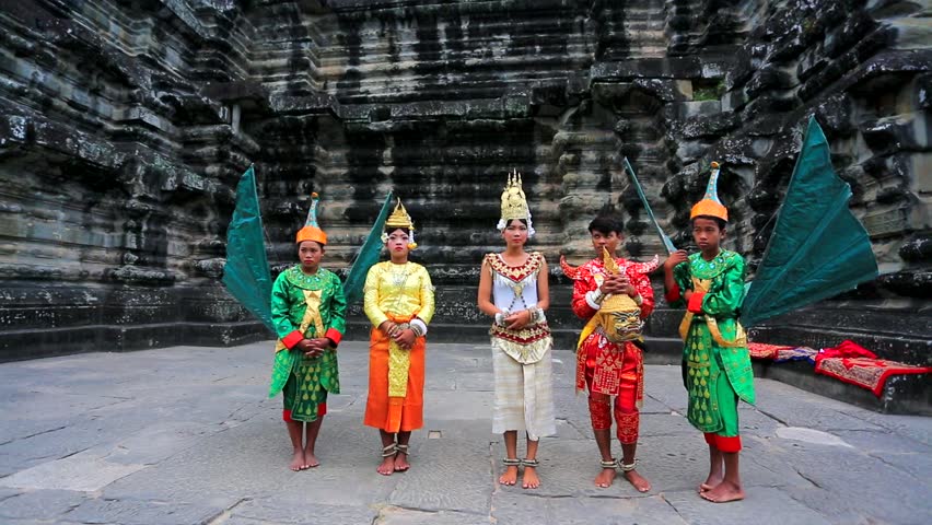 ANGKOR, CAMBODIA - CIRCA DECEMBER: Tourist pose with local people in traditional