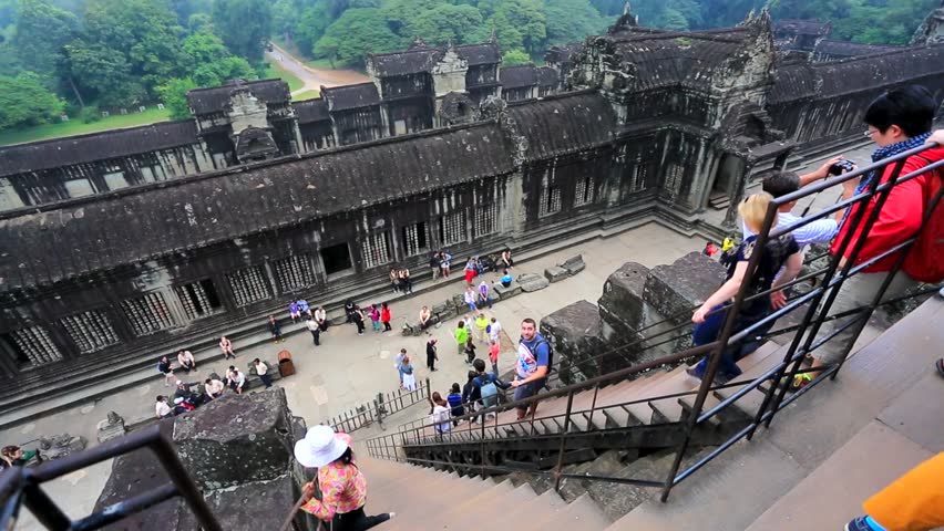 ANGKOR, CAMBODIA - CIRCA DECEMBER: tourists climbing steps of Angkor Wat, on