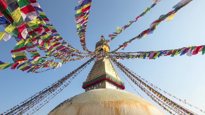 Timelapse: Colored flags fly on the stupa Boudhanath in Kathmandu, Nepal. (HD/25