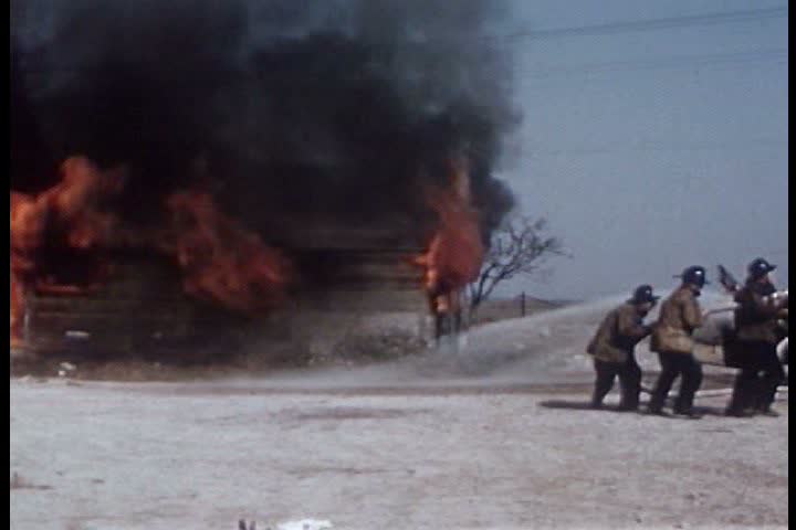 Firemen fight a house fire in 1951.