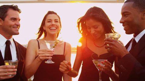 Smiling pretty diverse female and male friends enjoying cocktails and fun at city sunset party dressed in black shot on RED EPIC, 4K, UHD, Ultra HD resolution Stock Video