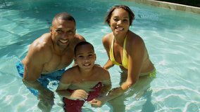 Overhead young ethnic family time together outdoors home swimming pool smiling to camera filming social media video self portrait shot on RED EPIC, 4K, UHD, Ultra HD resolution