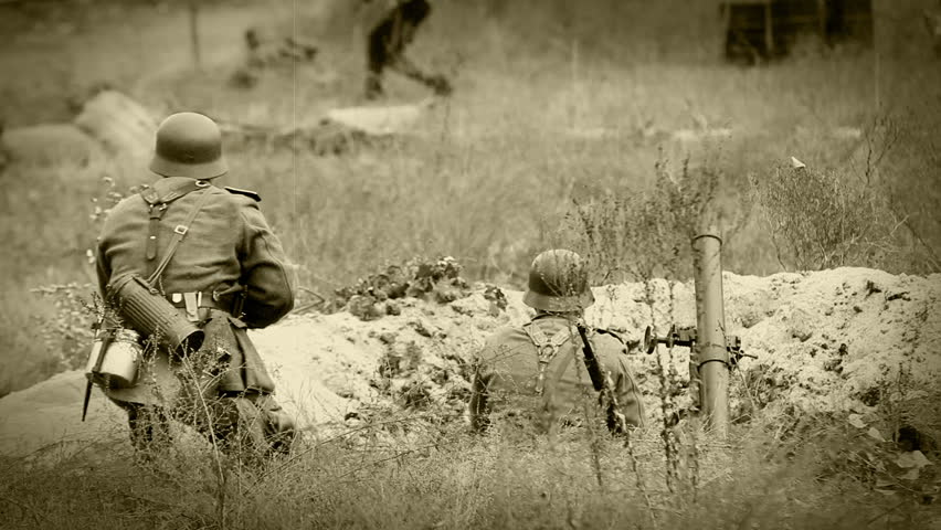 Nazi soldiers shooting with a rifle and mortar in trench . WWII old film movie