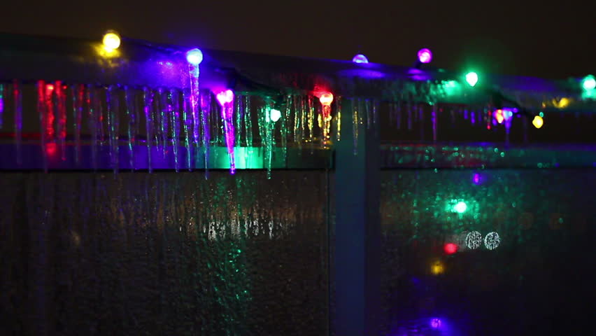 Icicle Colors 3. Colorful Christmas lights frozen over with icicles from a