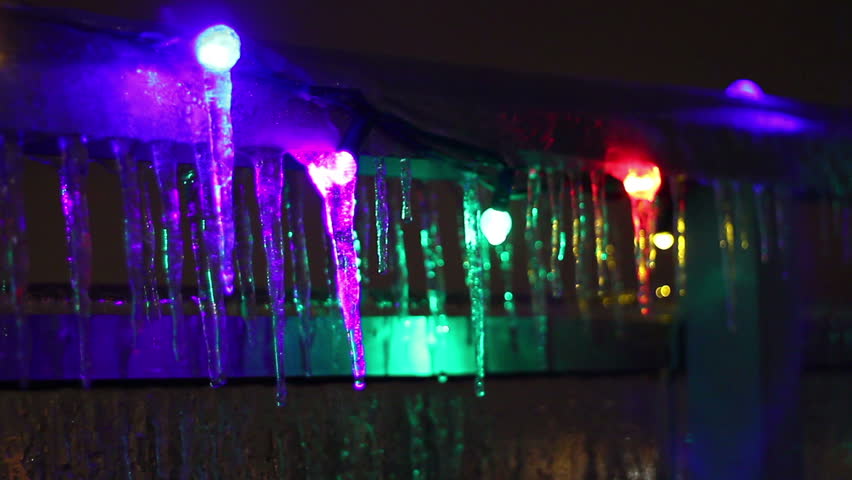 Icicle Colors 4. Colorful Christmas lights frozen over with icicles from a
