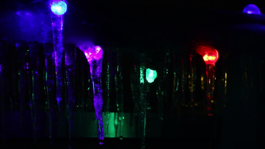 Icicle Colors 2. Colorful Christmas lights frozen over with icicles from a