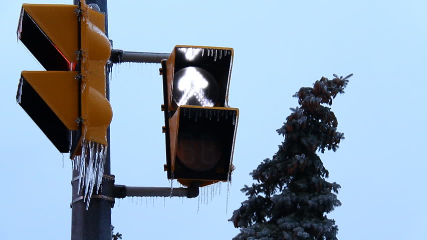 Icy Storm Crosswalk Sign Countdown. With icicles hanging from it after an