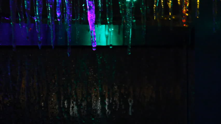 Icicle Colors 1. Colorful Christmas lights frozen over with icicles from a