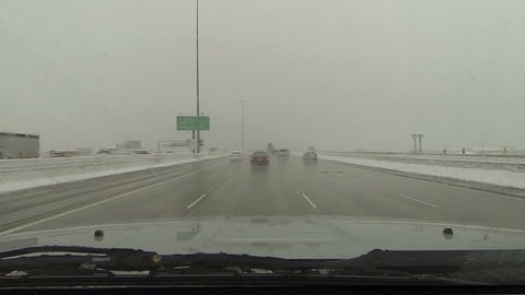 Driving interstate highway snow storm POV HD. Winter snow storm hit West and Midwest USA with extreme cold weather and snow. Dangerous driving conditions on snow packed and icy roads.