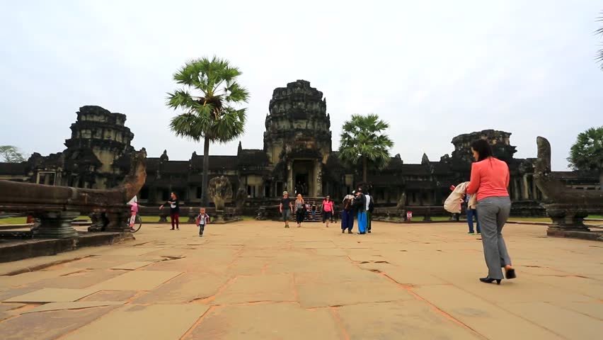 ANGKOR, CAMBODIA - CIRCA DECEMBER: Tourists visit Angkor Wat Temple, on circa
