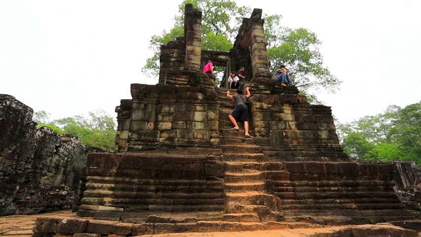ANGKOR, CAMBODIA - CIRCA DECEMBER: Tourists visit Bayon Temple, on circa