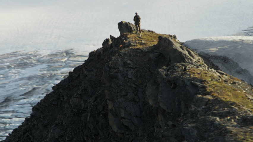 Aerial view male mountain climber ridge walking Chugach Range of mountains nr Troublesome Glacier, State of Alaska, USA shot on RED EPIC, 4K, UHD, Ultra HD resolution