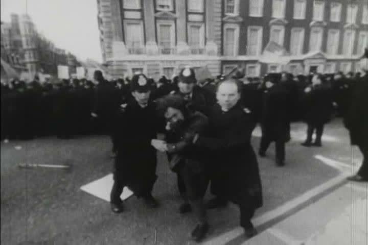 1970s black and white footage of people protesting the Vietnam War and being contained by police in London, England