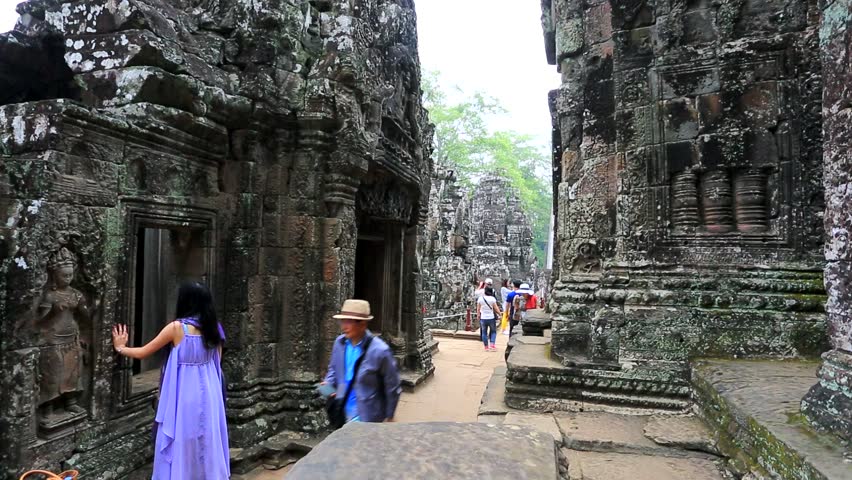 ANGKOR, CAMBODIA - CIRCA DECEMBER: Tourists visit Bayon Temple, on circa