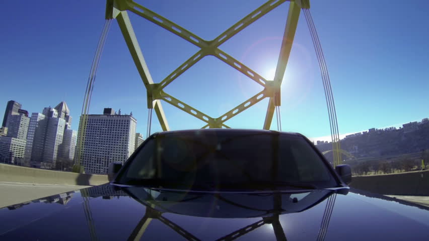 A reverse perspective of driving over the Fort Duquesne Bridge out of downtown