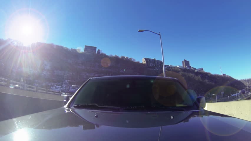 A reverse perspective of driving over the Fort Pitt Bridge in downtown