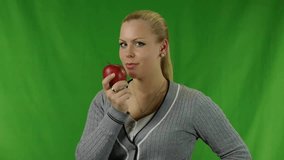 Young happy attractive woman holding red apple and smiling - Healthy food - Video footage to chroma-key background.
