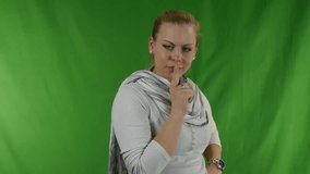 Young woman putting her finger to her lips for shh gesture - shhh secrets - Video footage to chroma-key background.