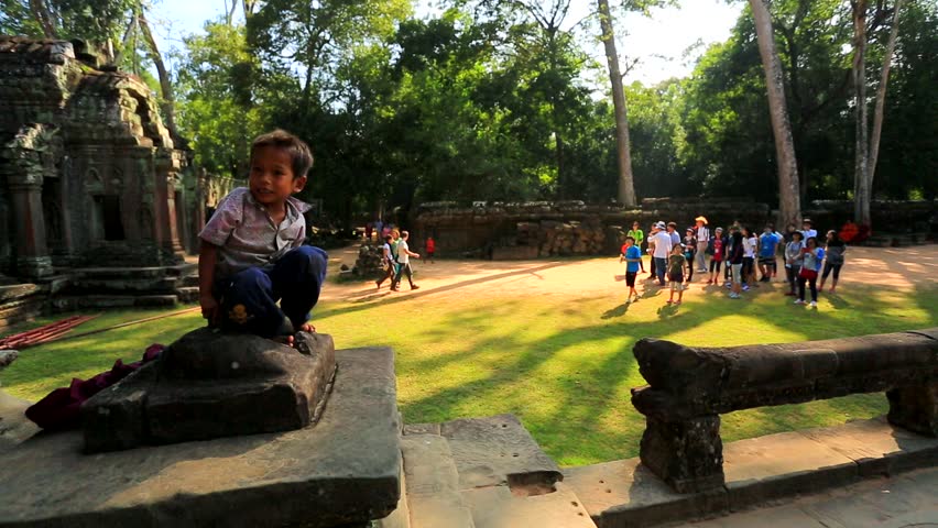 ANGKOR, CAMBODIA - CIRCA DECEMBER: Cambodian boy at Ta Prohm Temple, on circa