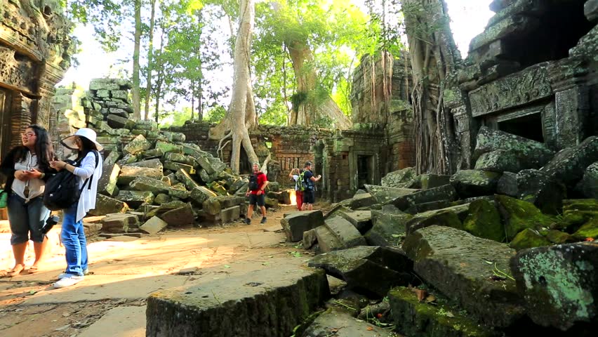 ANGKOR, CAMBODIA - CIRCA DECEMBER: Tourists visit Ta Prohm Temple, on circa