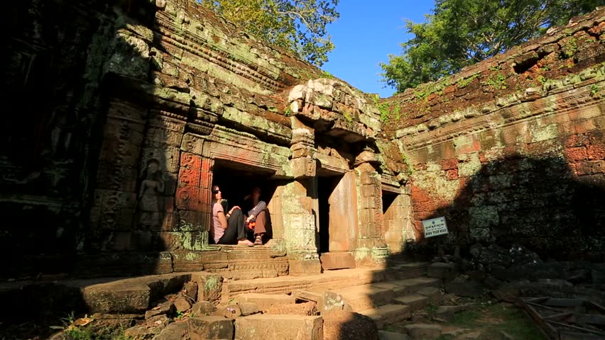 ANGKOR, CAMBODIA - CIRCA DECEMBER: Tourists visit Ta Prohm Temple, on circa