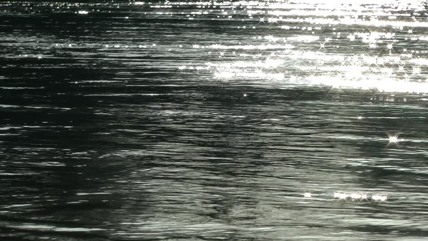 Sun reflections off river water with the sun's highlights and sparkling and
