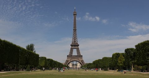 Eiffel Tower a Landmark in Paris Champ de Mars, People Commuting Passing Walking sunny day ( Ultra High Definition, Ultra HD, UHD, 4K, 2160P, 4096x2160 )