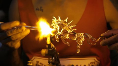 Blown glass by fire to create a horse./Glass Blowing