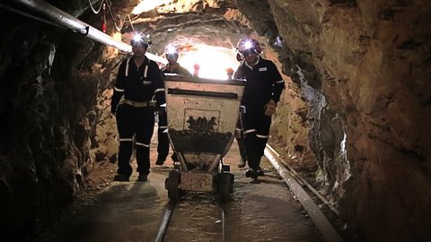 Mine entrance, workers inside tunnel to start labor shift
