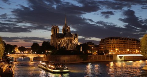 Paris City Illuminated Dusk Night Light Nighttime, Tourist Passengers Enjoy Boat Trip on Seine River near Notre Dame Cathedral Church ( Ultra High Definition, Ultra HD, UHD, 4K, 2160P, 4096x2160 )