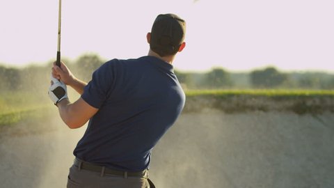Caucasian male golfer playing weekend round golf concentrating on hitting his ball out of sand bunker shot on RED EPIC, 4K, UHD, Ultra HD resolution