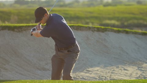 Professional male Caucasian golfer standing sand bunker golf course vacation resort playing ball shot on RED EPIC, 4K, UHD, Ultra HD resolution